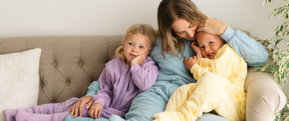 mum with her two children in pastel colour sleeping bags