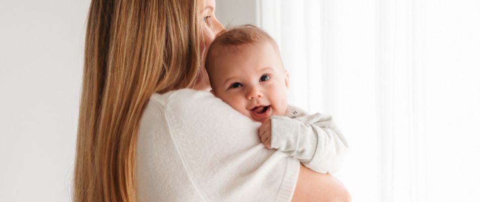mum cuddling newborn baby
